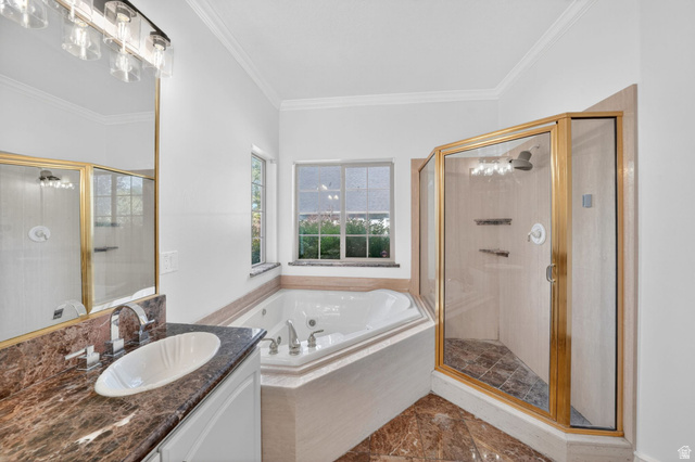 883 East 700 South Springville, UT 84663 - Photo 23 of 59 Corner jetted tub with tile surround, a separate glass-enclosed shower with gold-tone framing, and a vanity featuring a vessel sink set into a dark, veined countertop