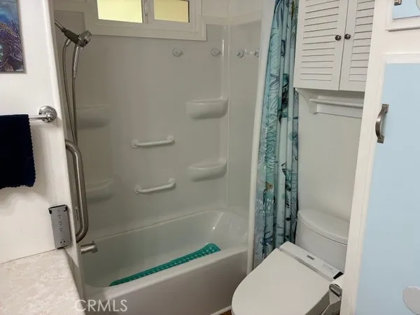 a bathroom with a shower and a toilet