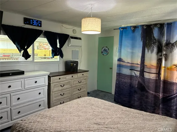 a bedroom with a bed and window