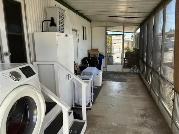 a view of a hallway with washer and dryer