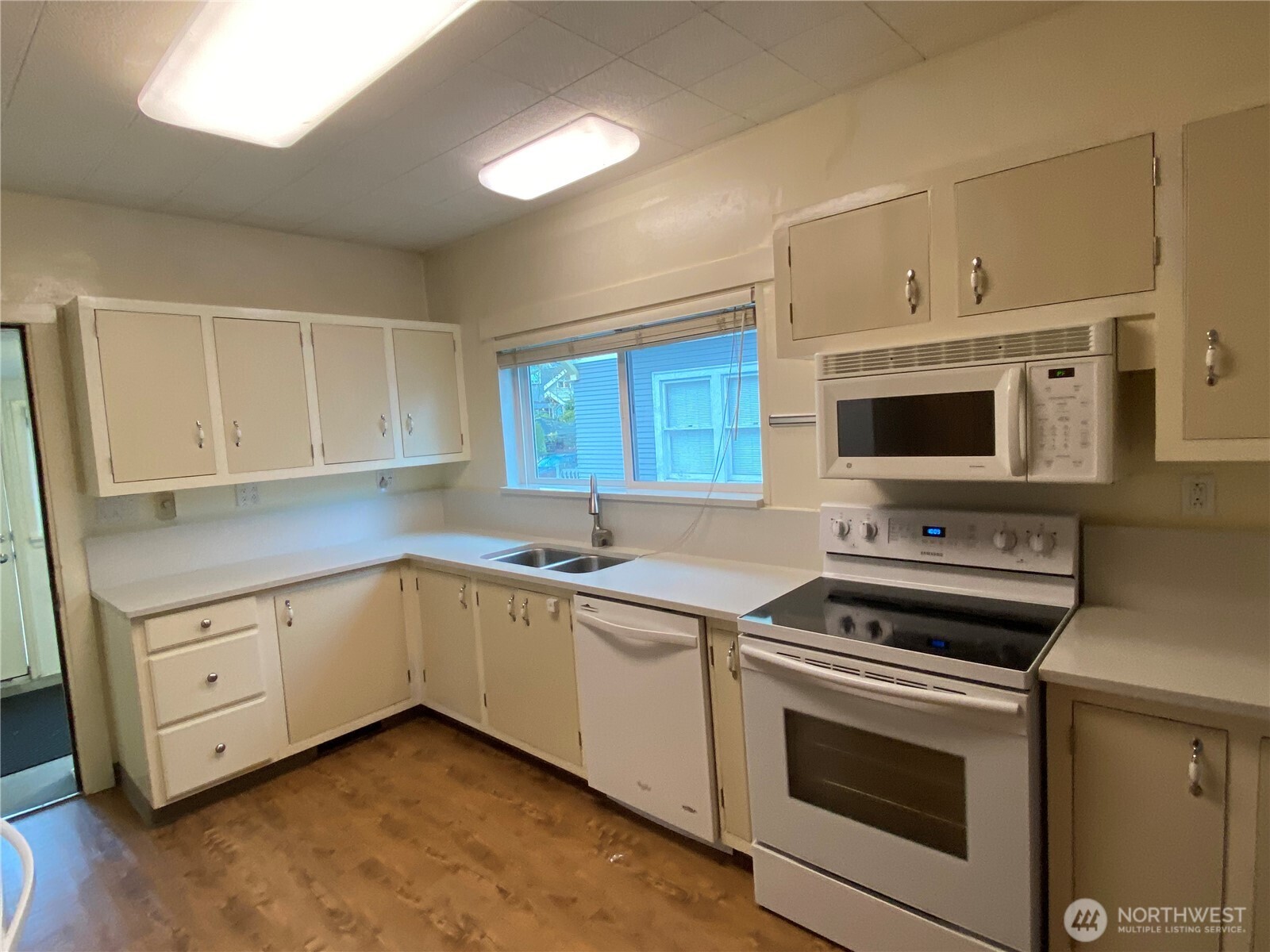809 Northeast 62nd Street Seattle, WA 98115 - Photo 2 of 12 a kitchen with a sink stove and microwave