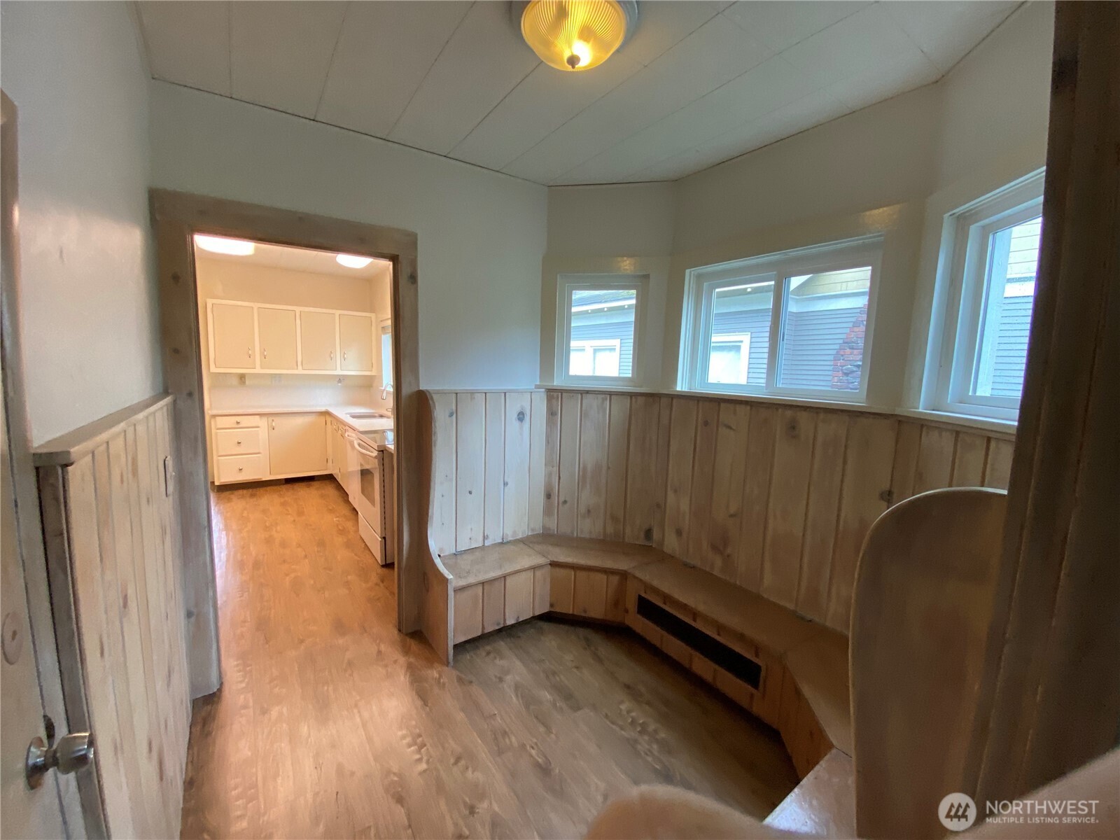 809 Northeast 62nd Street Seattle, WA 98115 - Photo 4 of 12 a view of an empty room with wooden floor and a window