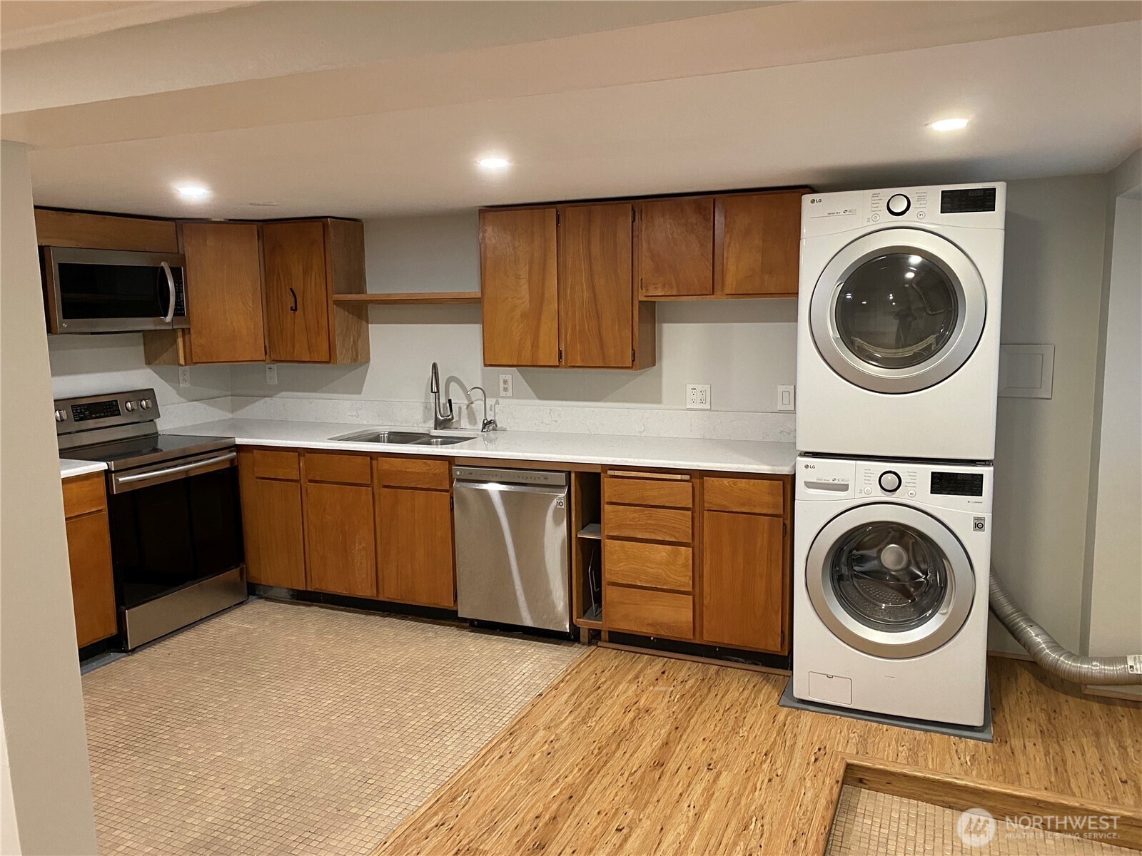 809 Northeast 62nd Street Seattle, WA 98115 - Photo 5 of 12 a kitchen with a sink a stove top oven and cabinets