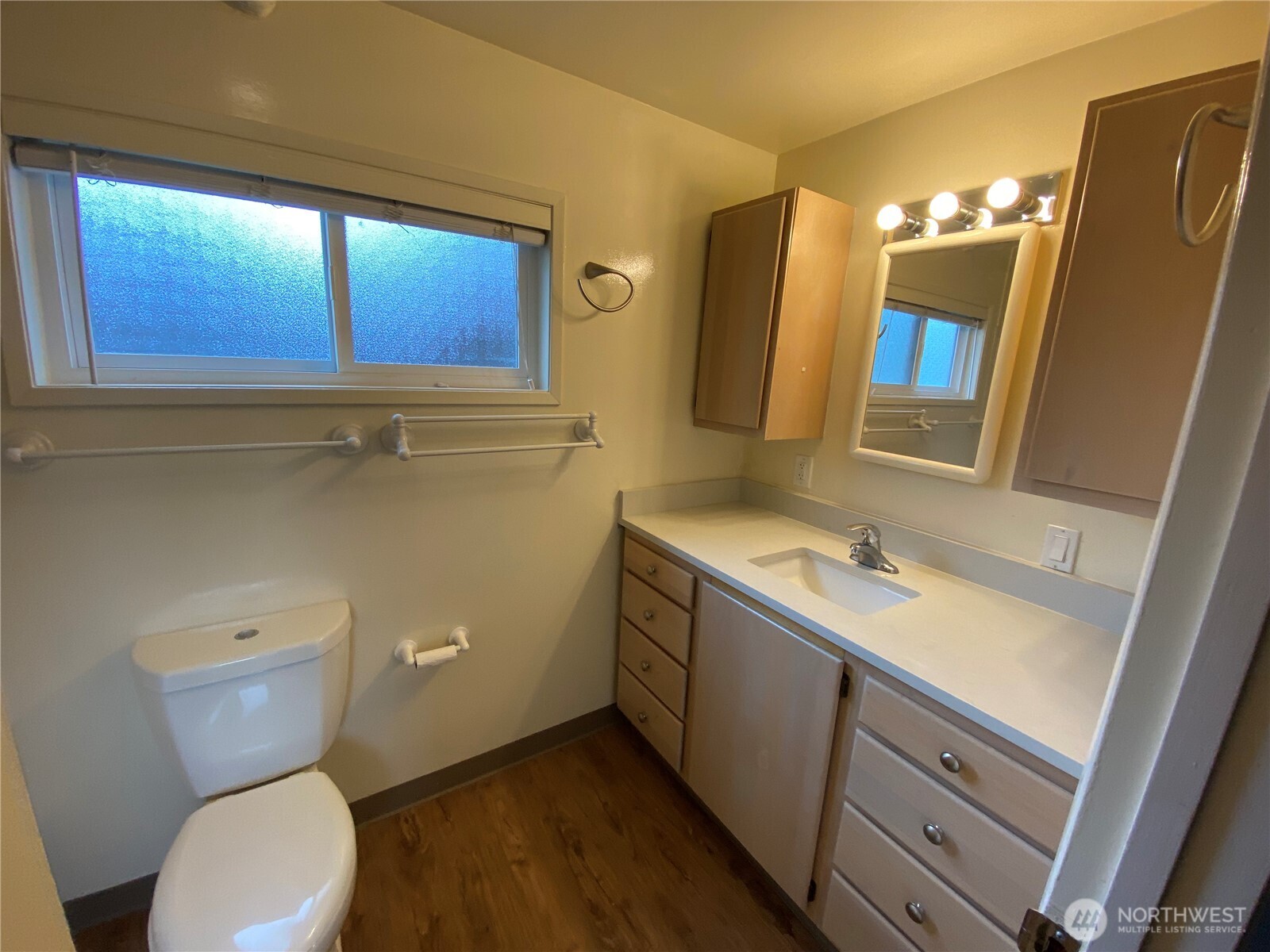 809 Northeast 62nd Street Seattle, WA 98115 - Photo 8 of 12 a bathroom with a toilet sink and mirror
