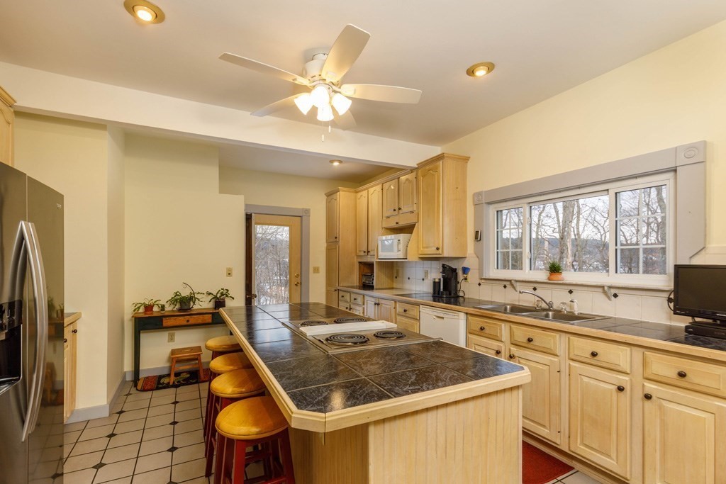 225 Wallingford Avenue Athol, MA 01331 - Photo 2 of 24 a kitchen with a stove a sink dishwasher a refrigerator and cabinets with wooden floor