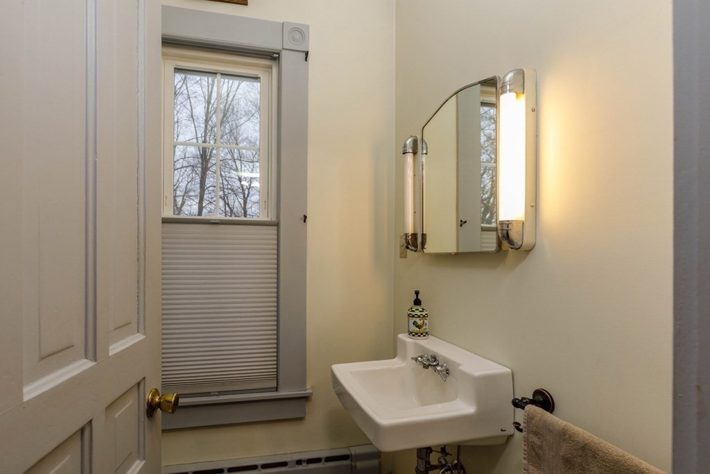 225 Wallingford Avenue Athol, MA 01331 - Photo 8 of 24 a bathroom with a sink a mirror and a window