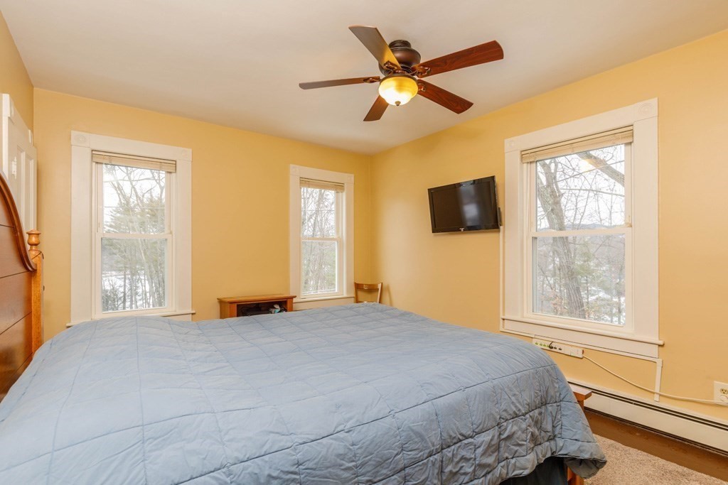225 Wallingford Avenue Athol, MA 01331 - Photo 10 of 24 a bedroom with a large bed and a large window
