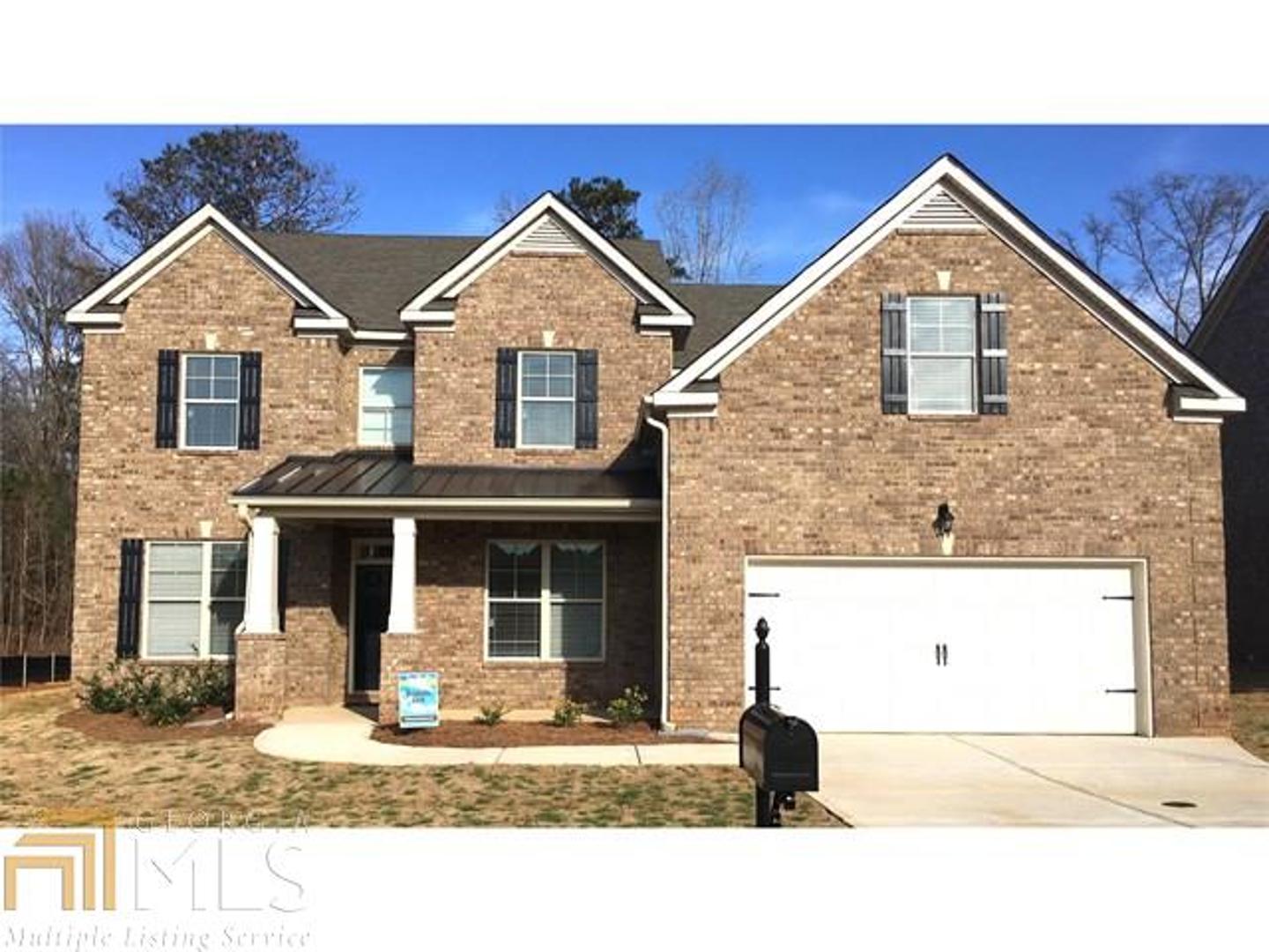 3261 Alhambra Circle, Unit 51 Hampton, GA 30228 - Photo 1 of 1 a front view of a house with a yard