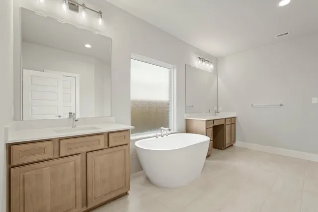 a bathroom with a white tub sink
