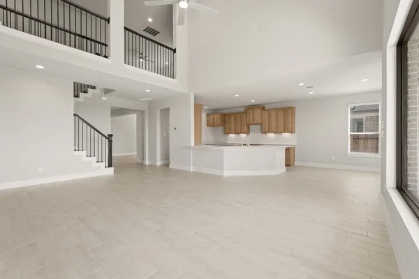 a view of a big room with kitchen and windows
