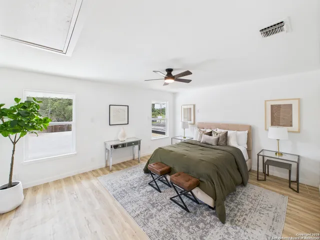 a bedroom with a bed and a potted plant