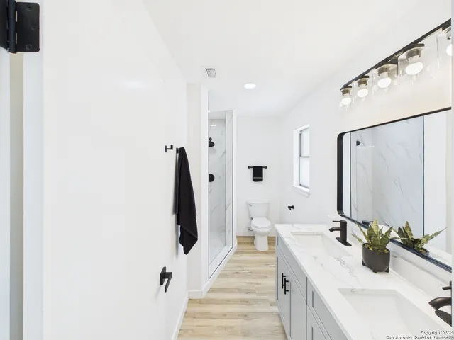 a bathroom with a double vanity sink and mirror