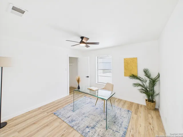 a living room with furniture and a potted plant