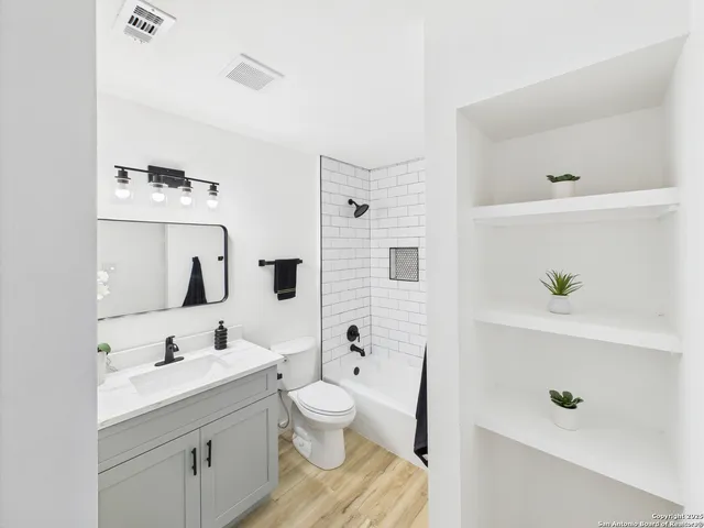 a bathroom with a sink a toilet and tub