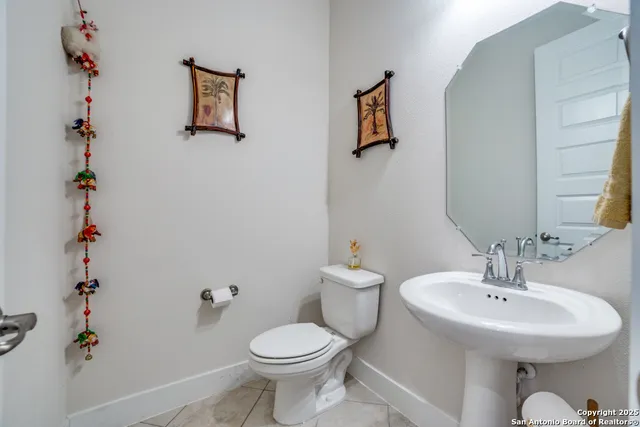 a bathroom with a sink mirror and toilet