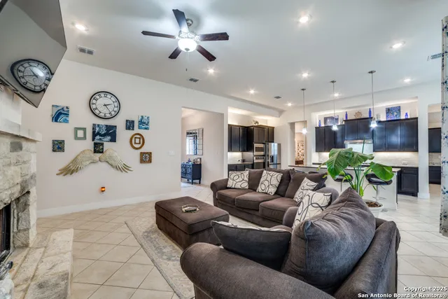 a living room with furniture kitchen and a chandelier