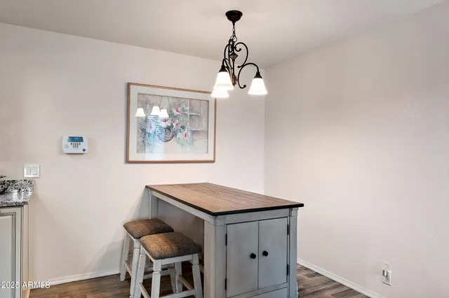 a view of a dining room with a table and chairs