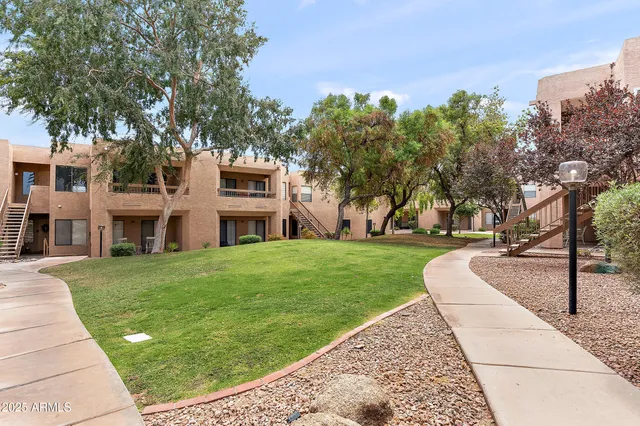 a front view of a building with a garden