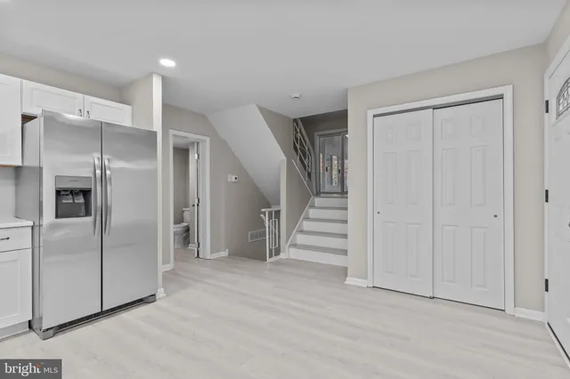 a view of an empty room with a kitchen