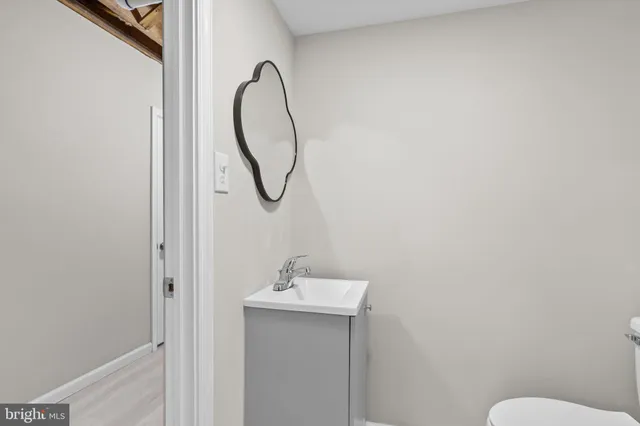 a bathroom with a sink a toilet and a mirror