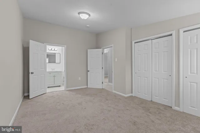 a view of an empty room and closet area