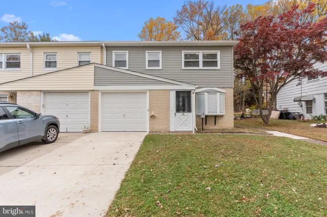 a view of a car parked in front of a white house