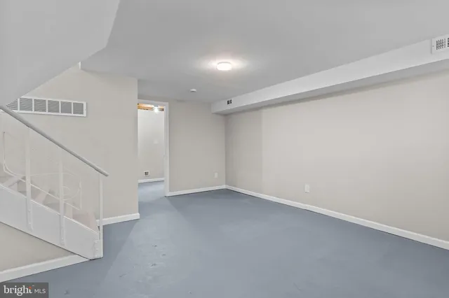 a view of an empty room with stairs