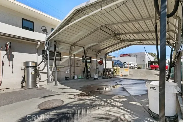 a roof deck with table and chairs and potted plants