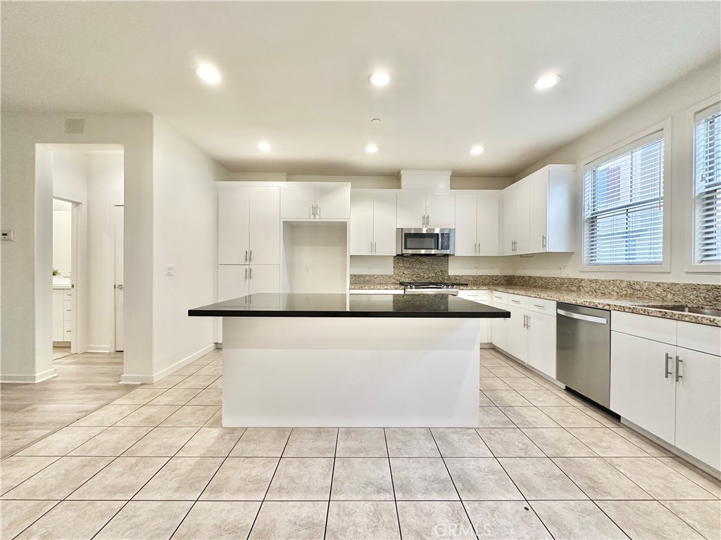 21042 Cornerstone Drive Walnut, CA 91789 - Photo 6 of 29 a large kitchen with granite countertop a stove a sink and a refrigerator