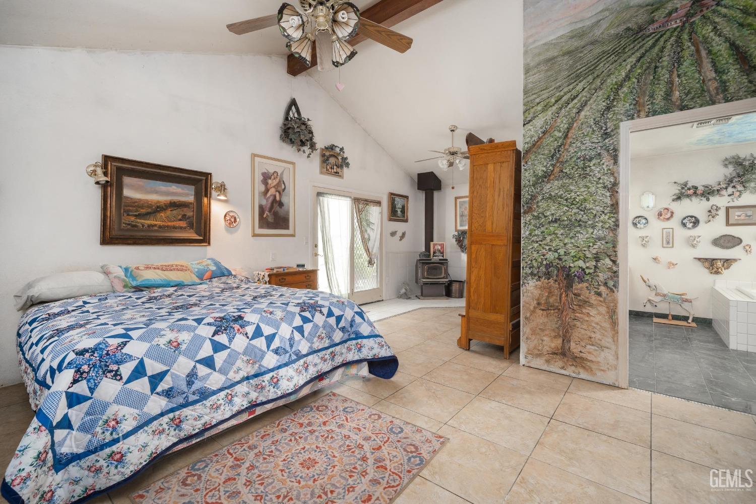 Undisclosed Address Taft, CA 93268 - Photo 13 of 38 a bedroom with a bed and a chandelier