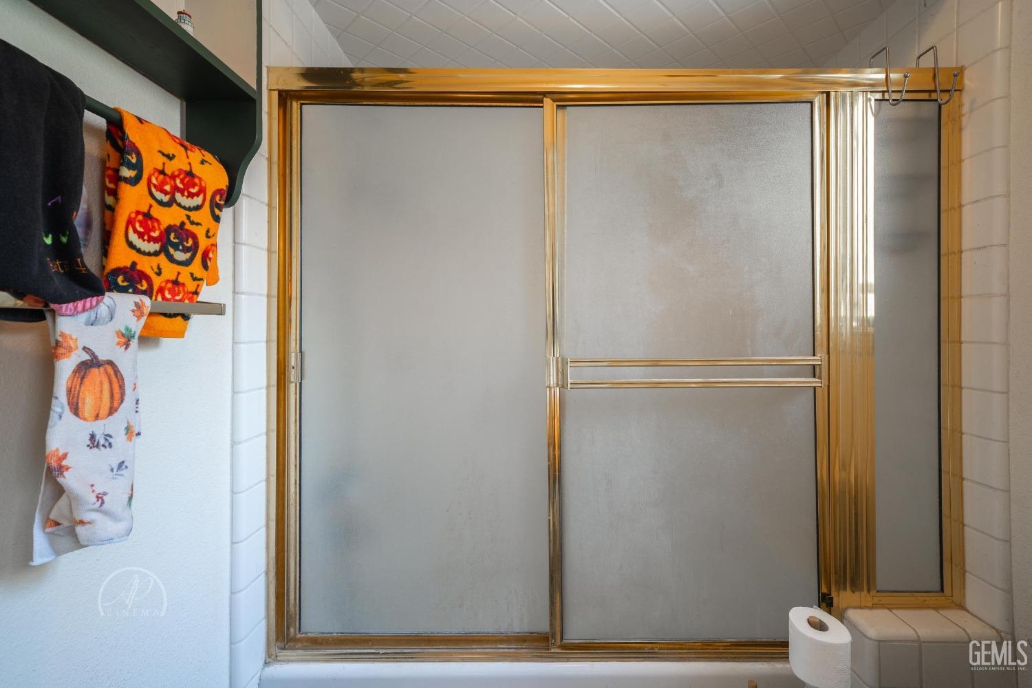 Undisclosed Address Taft, CA 93268 - Photo 19 of 38 a bathroom with a refrigerator and a shower curtain