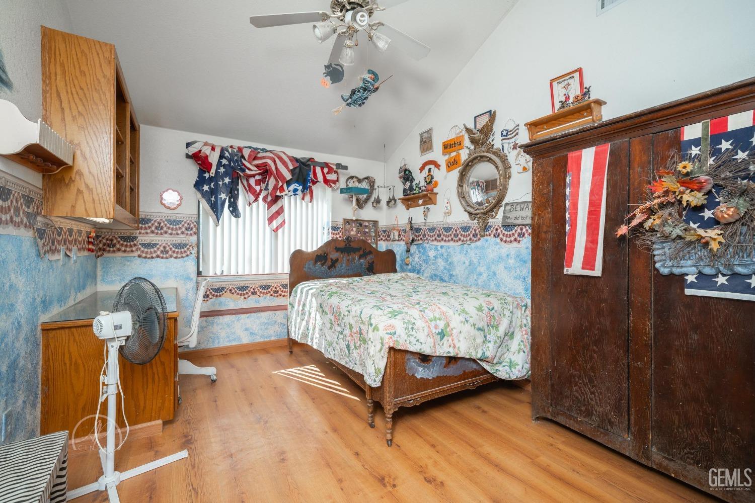 Undisclosed Address Taft, CA 93268 - Photo 22 of 38 a bedroom with a bed and wooden floor