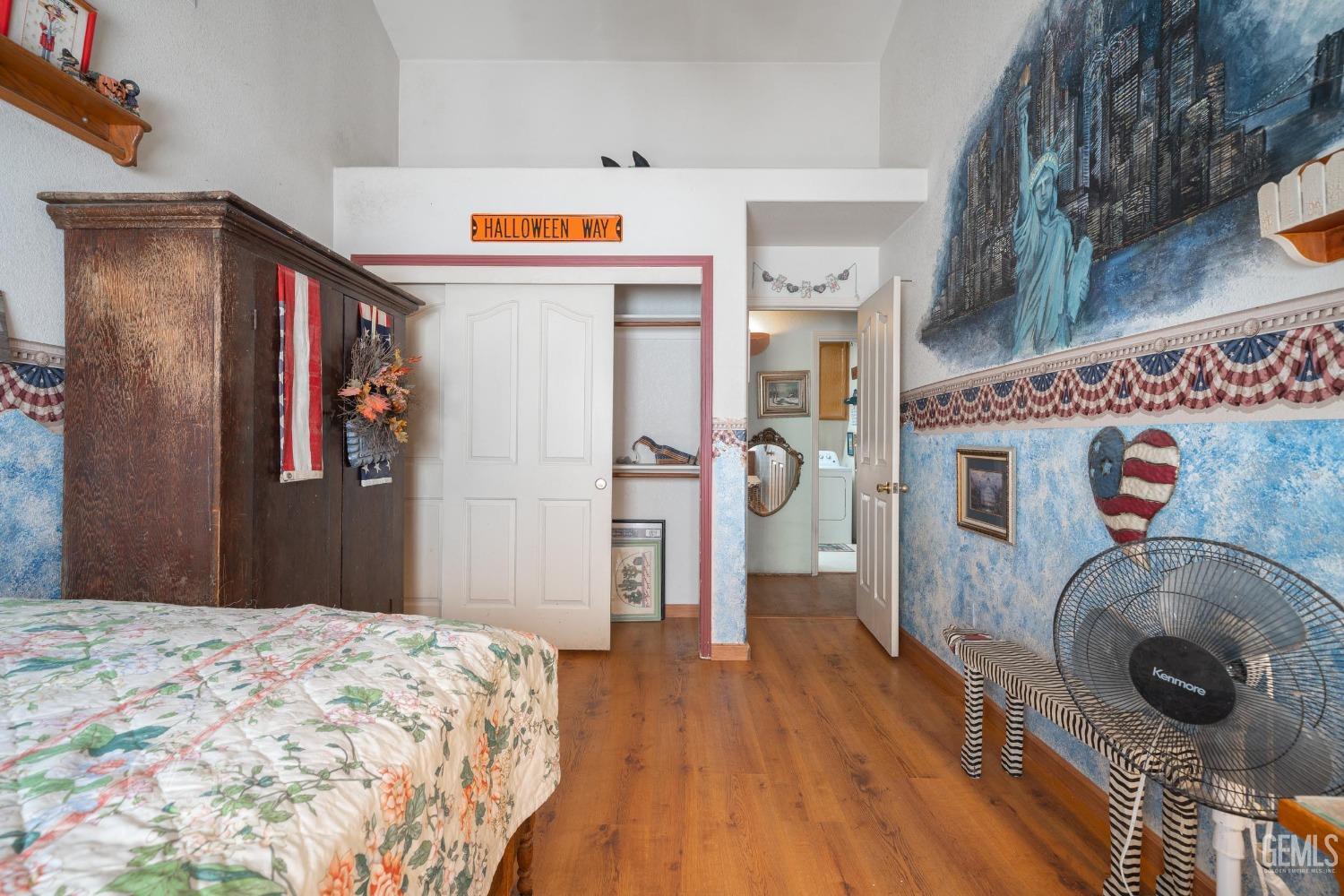 Undisclosed Address Taft, CA 93268 - Photo 23 of 38 a bedroom with a bed and wooden floor