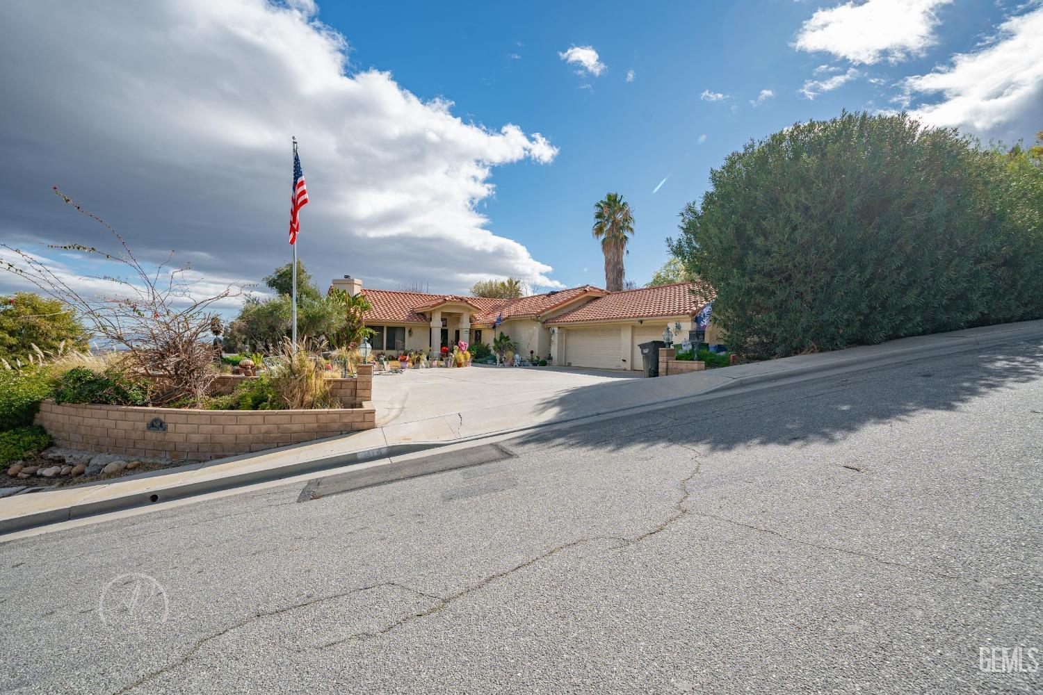 Undisclosed Address Taft, CA 93268 - Photo 3 of 38 a street view with flower plants and wooden fence