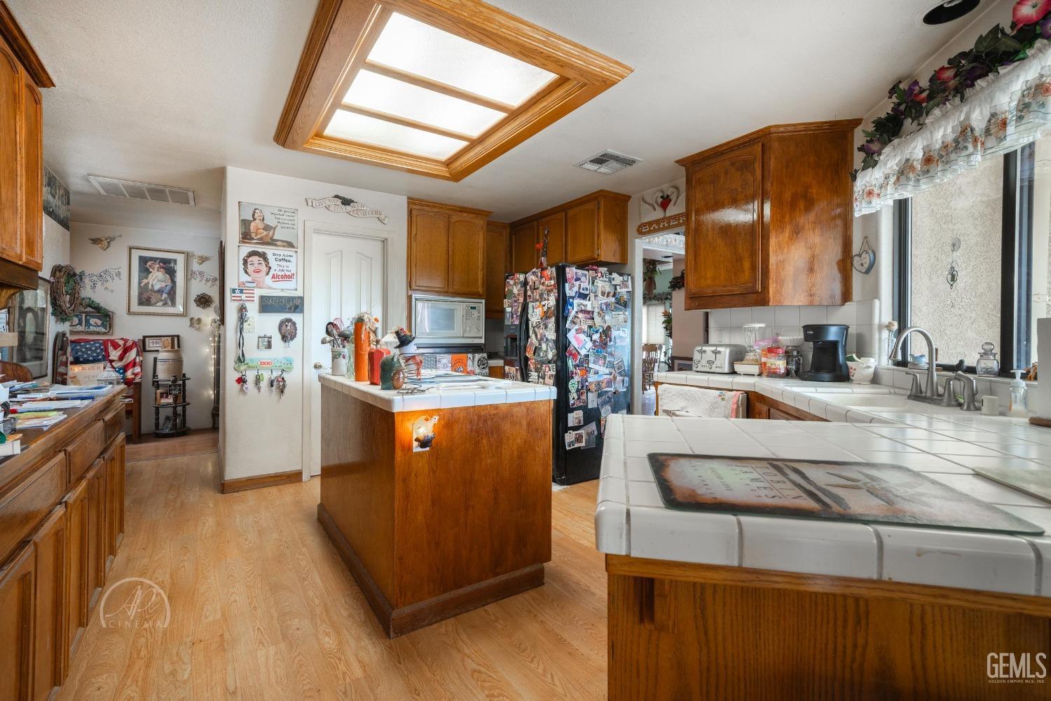 Undisclosed Address Taft, CA 93268 - Photo 9 of 38 a room with furniture a flat screen tv and a refrigerator