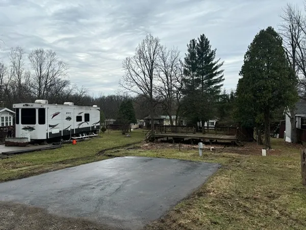 a view of a house with backyard and sitting area