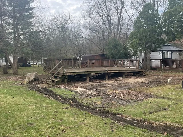 a view of a wooden deck area and lake view
