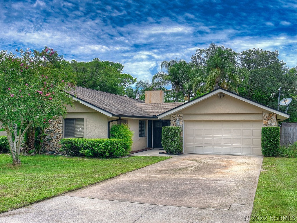 401 East Citrus Street Altamonte Springs, FL 32701 - Photo 1 of 36 a view of a house with a yard plants and a large tree