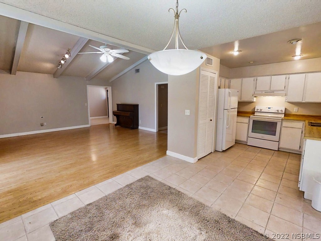 401 East Citrus Street Altamonte Springs, FL 32701 - Photo 17 of 36 a view of a kitchen with a sink and a refrigerator