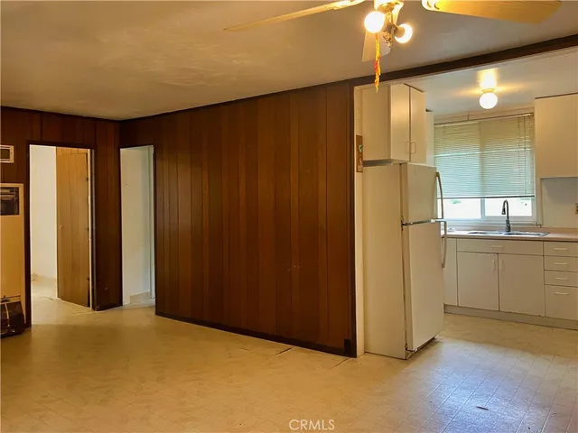 a view of a kitchen with a refrigerator and a microwave