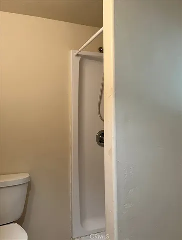 a bathroom with a shower and toilet
