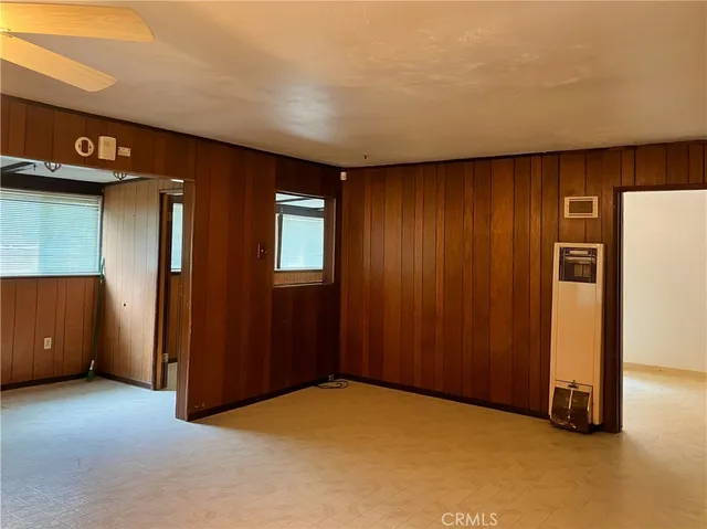 an empty room with closet and windows