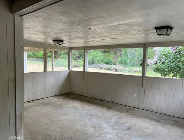 an empty room with large windows