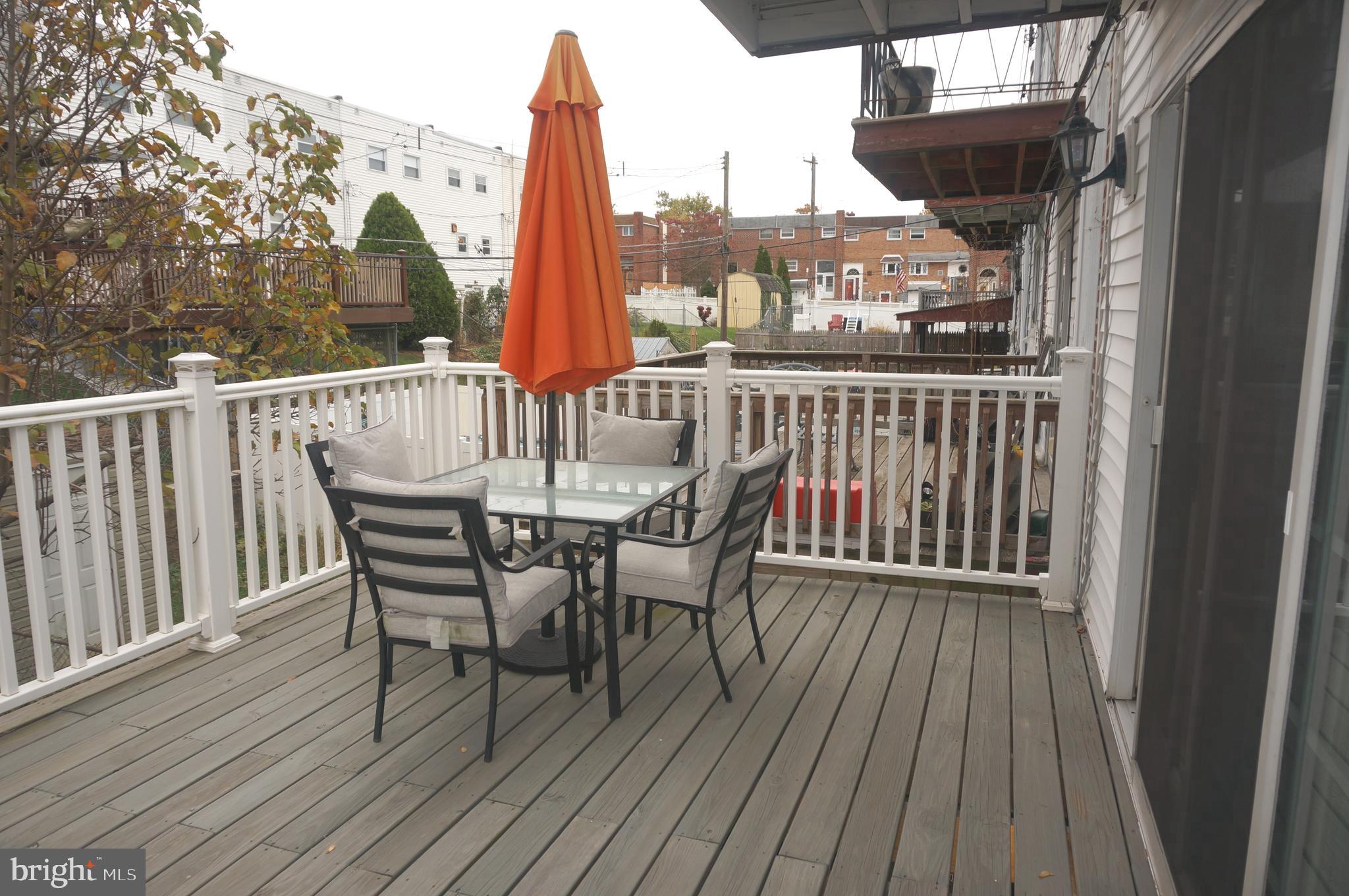 3599 C Nottingham Lane Philadelphia, PA 19114 - Photo 28 of 58 a view of a deck with table and chairs and wooden floor