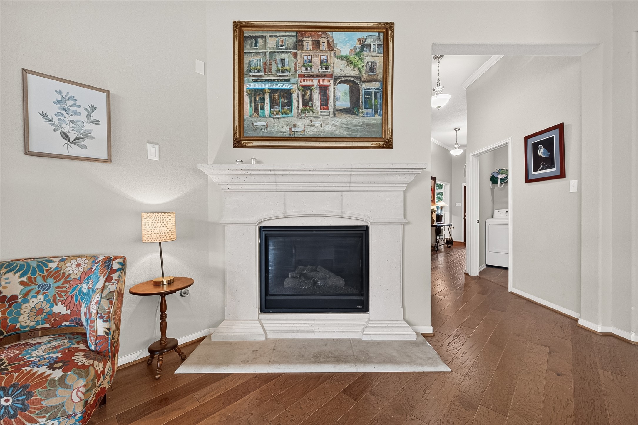 4910 Culver Lane Rosenberg, TX 77471 - Photo 20 of 50 This living space features a classic white fireplace as a focal point, complemented by engineered wood floors and gas logs.