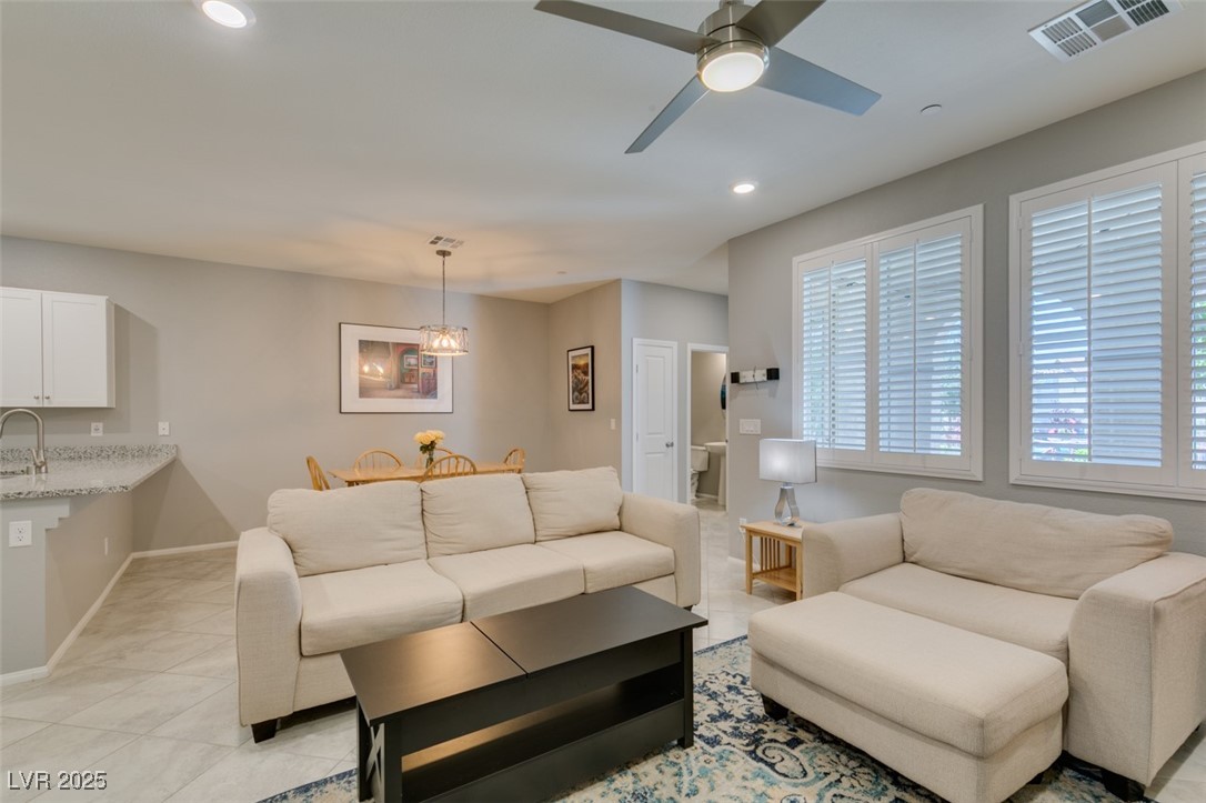 2870 Turnstone Ridge Street Henderson, NV 89044 - Photo 11 of 50 Living room featuring recessed lighting, a ceiling fan, light tile patterned floors, and baseboards