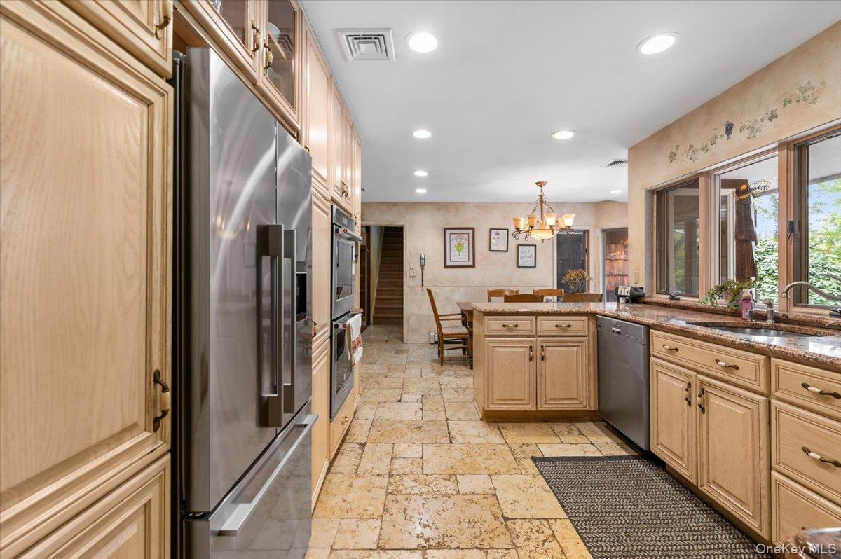 6 Apex Road Melville, NY 11747 - Photo 13 of 50 a large white kitchen with stainless steel appliances granite countertop a refrigerator and a sink