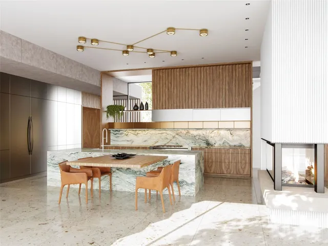 a kitchen with stainless steel appliances kitchen island granite countertop a table and chairs in it