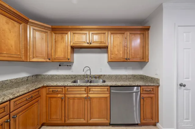 a kitchen with stainless steel appliances granite countertop a sink and cabinets with wooden floor