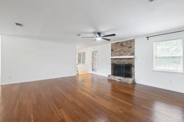 wooden floor in an empty room with a fireplace